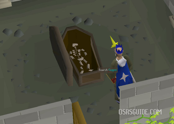 return the skull to the lumbridge graveyard by using it on the coffin to finish your quest